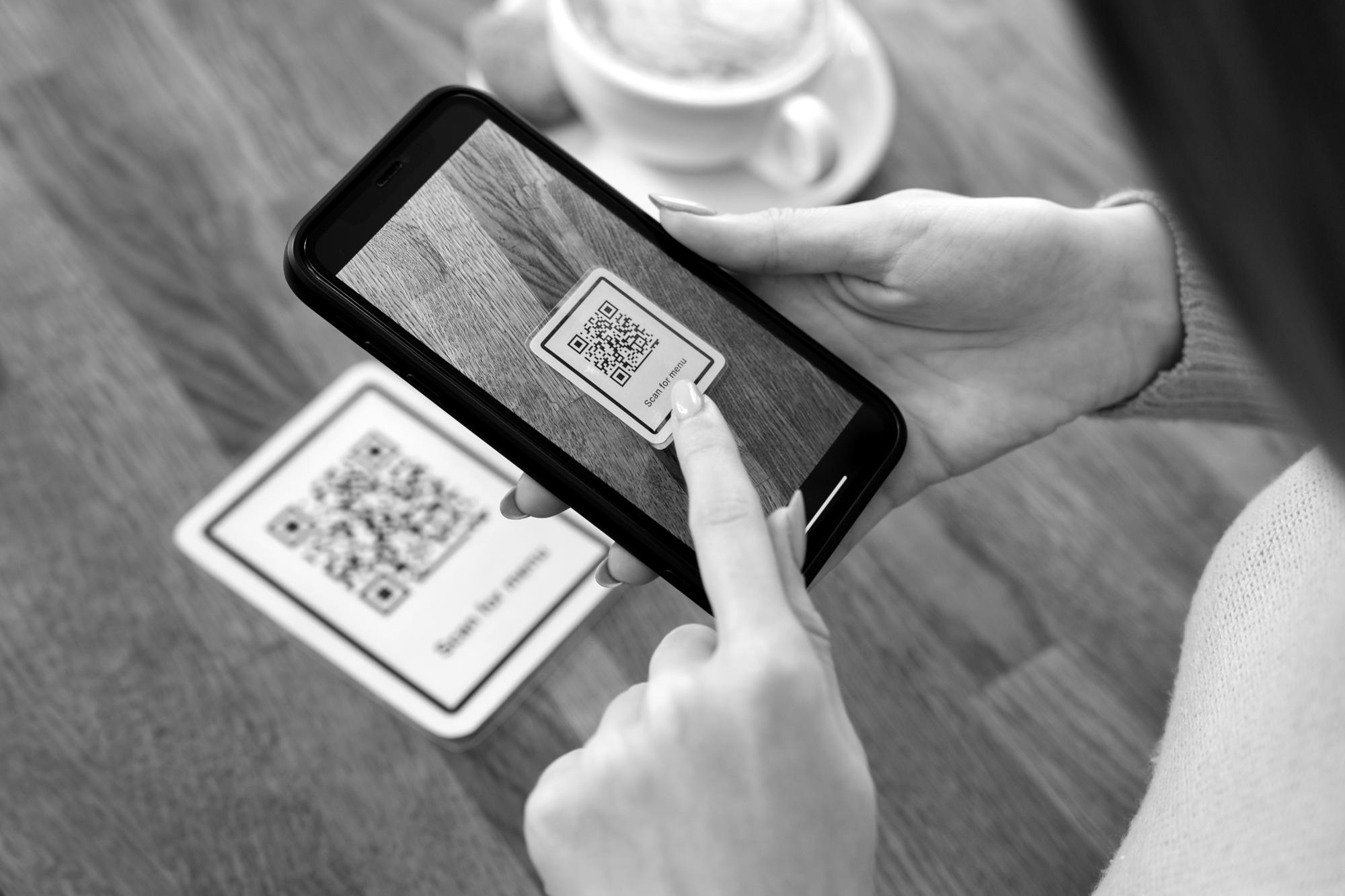 Customer scanning a PromptPay QR code on a phone to buy USDT